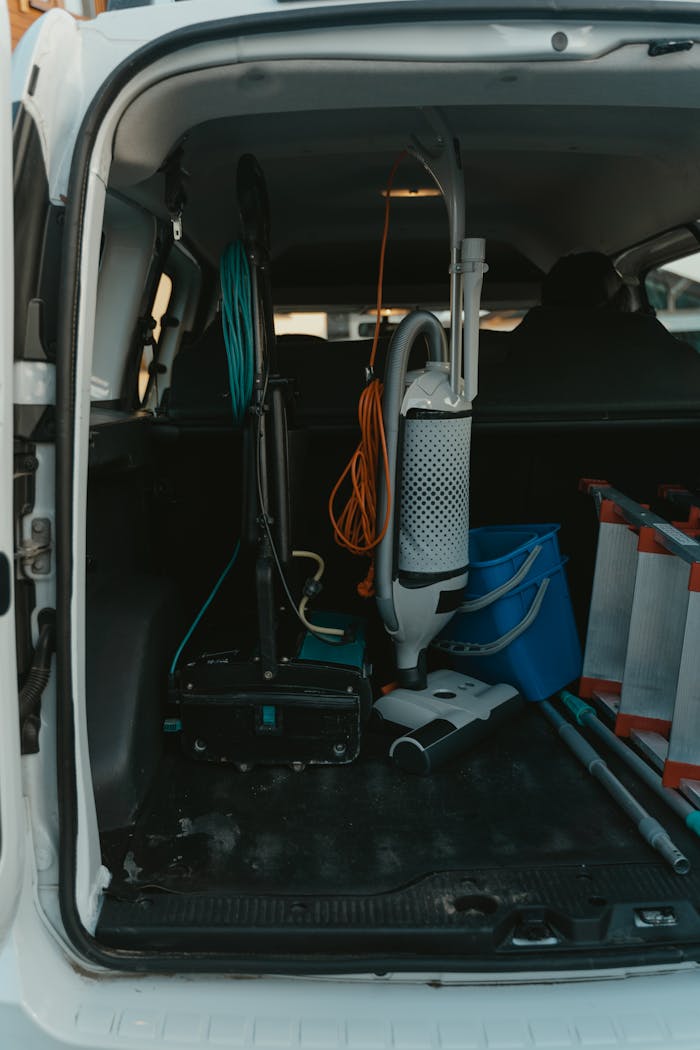Cleaning supplies and tools organized in a van ready for housekeeping service.